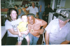Chief takes picture with little boy at VIdor History Club meeting. To the left of the chief is Barney Anders.